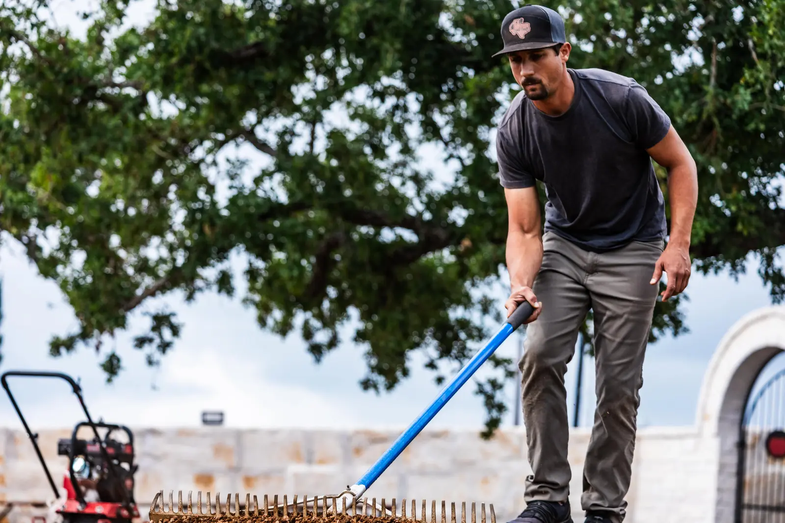 Raking base course to grade